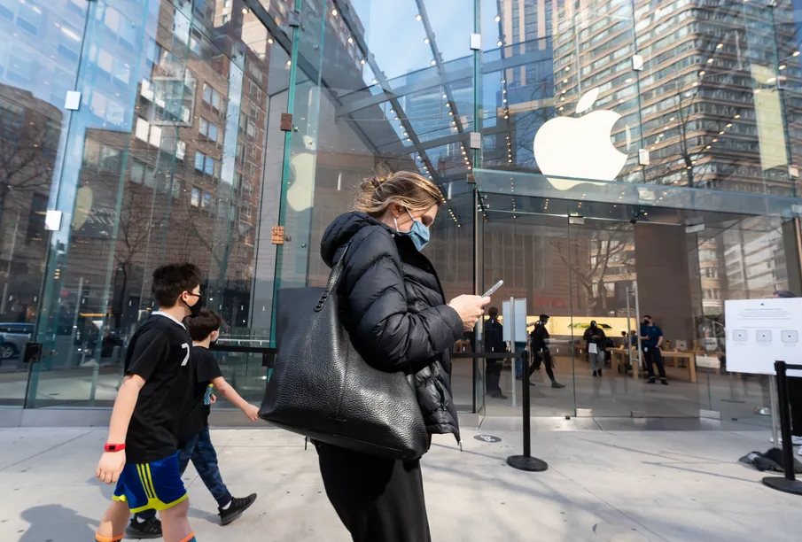 People walk outside the Apple Store on the Upper West Side on March 12th, 2021 in New York City. Photo by Noam Galai/Getty Images