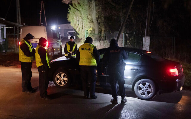 Police officers gather outside a grain depot where the Polish Foreign Ministry said a Russian-made missile fell and killed two people in Przewodow, eastern Poland, on November 15, 2022. (AP Photo)