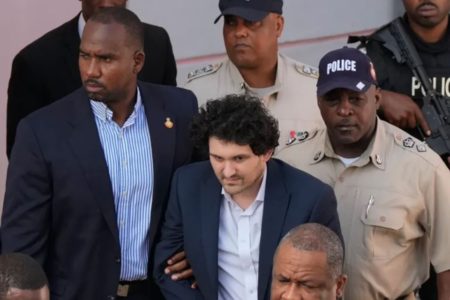 FTX founder Sam Bankman-Fried, centre, was arrested December 13 in the Bahamas where he lives [File: Rebecca Blackwell/AP Photo]