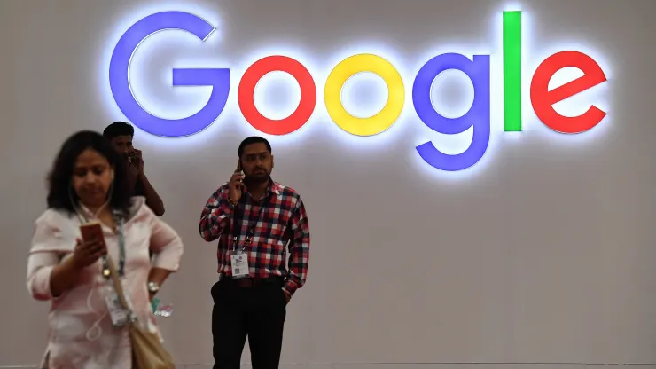 Indian visitors talk on their mobile phones outside the Google stall at the India Mobile Congress in New Delh Prakash Singh | AFP | Getty Images