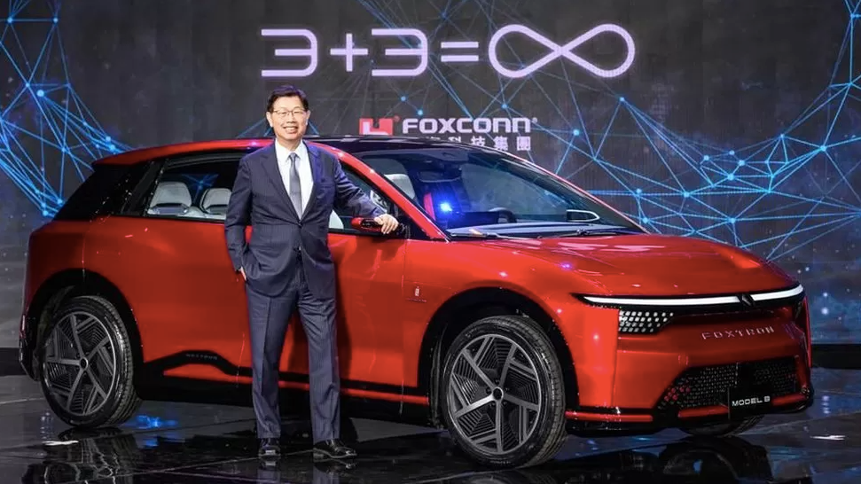 Foxconn chairman Young Liu with one of the firm's electric cars