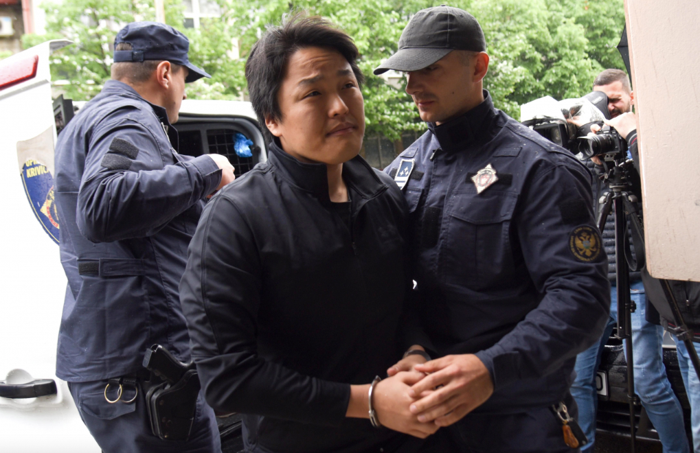 Police officers escort South Korean crypto mogul Do Kwon (center) in Podgorica, Montenegro, 11 May 2023. (EPA-Yonhap)