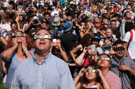 People wearing protective eye glasses watch the solar eclipse at the Griffith Observatory in Los Angeles Monday, Aug. 21, 2017. (AP Photo/Richard Vogel)