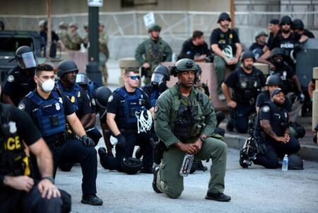 Police officers in Atlanta kneel with protesters on June 1, following a white police officer’s killing of George Floyd, an African American, in Minneapolis on May 25. (CNS photo/Dustin Chambers, Reuters)